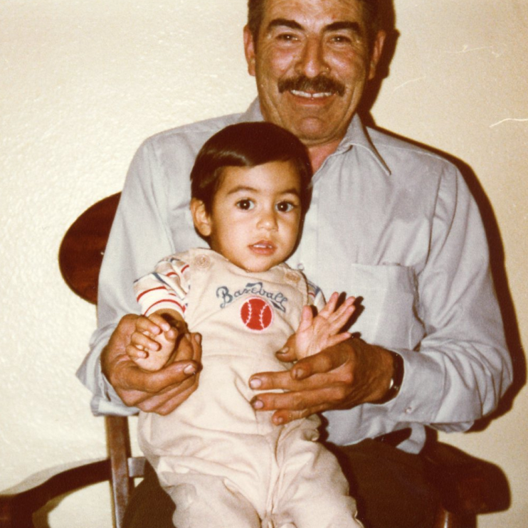 Young Robert Rivas sitting on his grandfather's lap